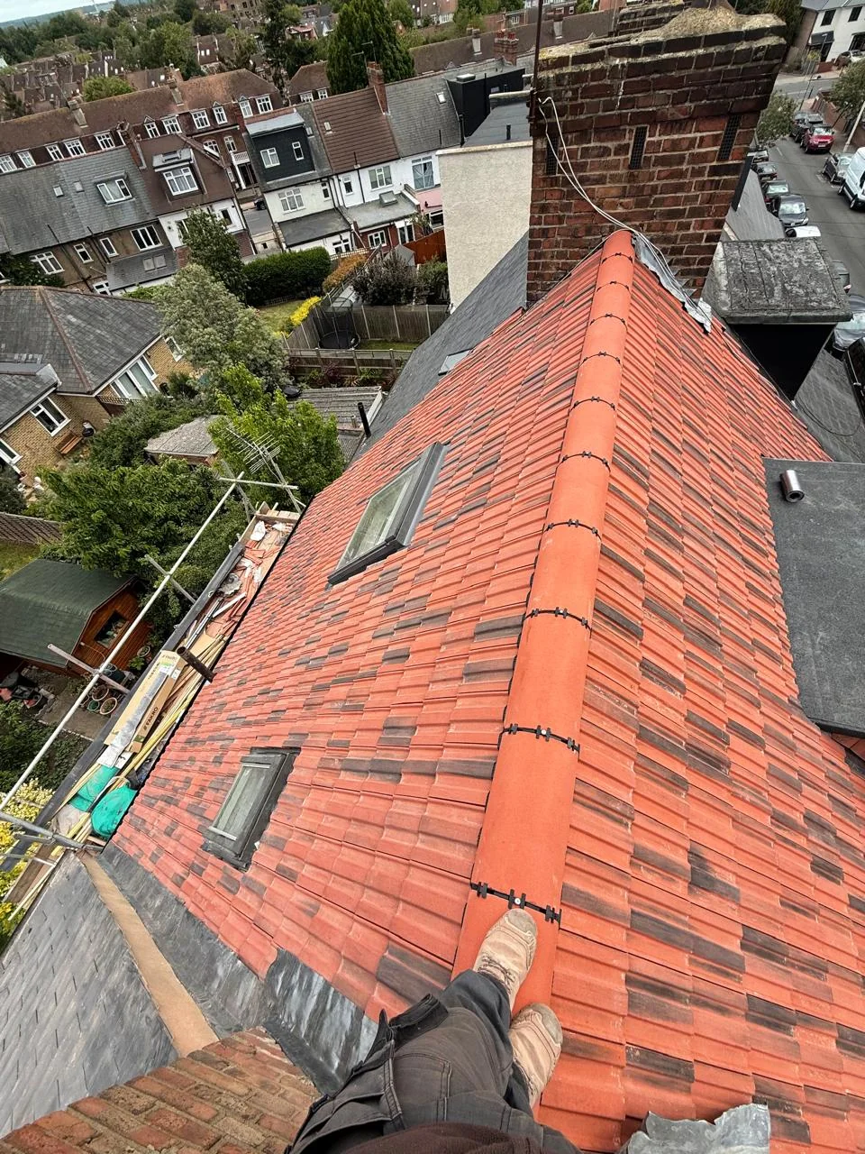 Existing red tiled roof viewed along the ridge before renewal